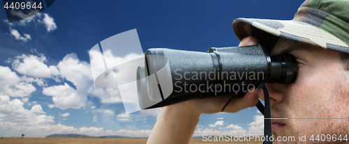 Image of close up of soldier face looking to binocular