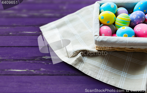 Image of close up of colored easter eggs in basket