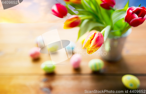 Image of close up of tulip flowers and easter eggs