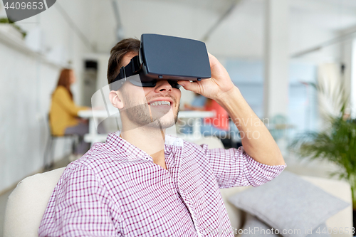 Image of happy man with virtual reality headset at office