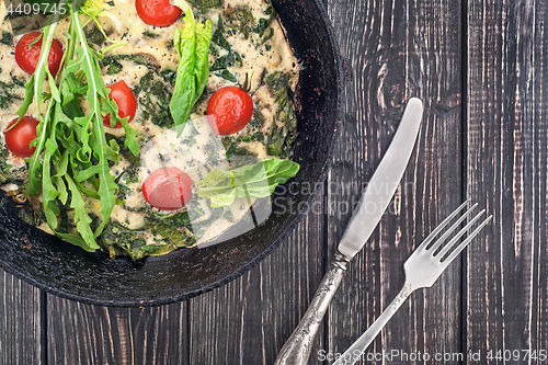 Image of Fritatta in pan with fork and knife