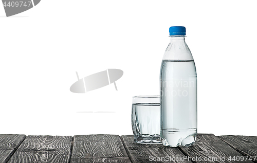 Image of Plastic bottle and a glass with water