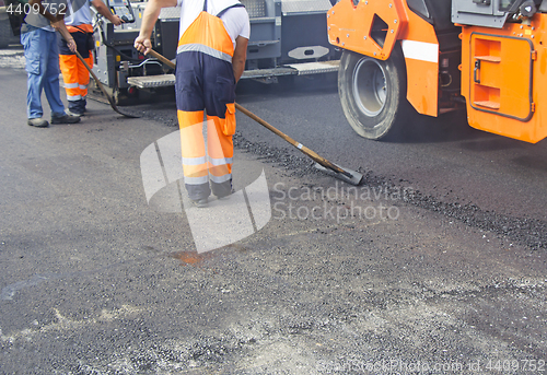 Image of Construction workers on asphalting and road repair