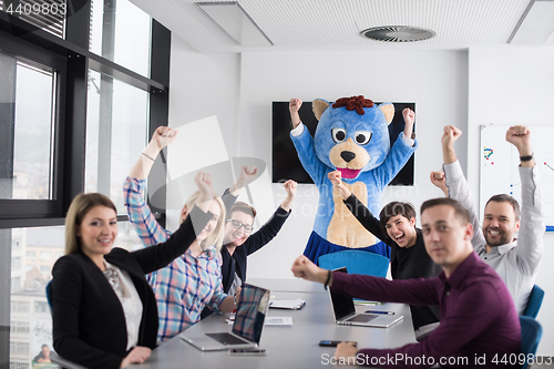 Image of boss dresed as bear having fun with business people in trendy of