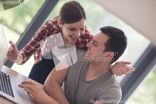 Image of happy young couple buying online