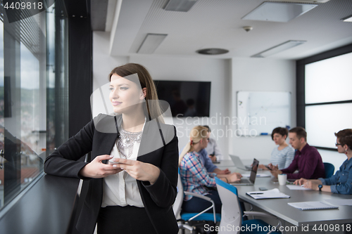 Image of Business Girl Standing In A Modern Building Near The Window With