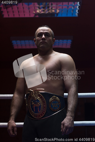 Image of kick boxer with his championship belt