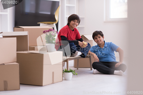 Image of boys with cardboard boxes around them