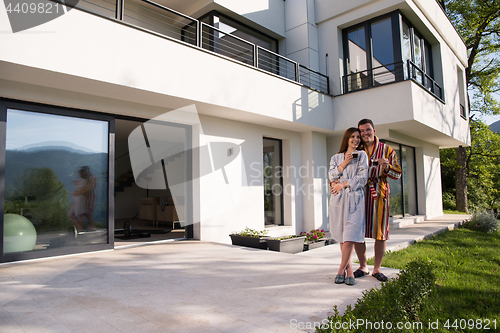Image of Young beautiful couple in bathrobes