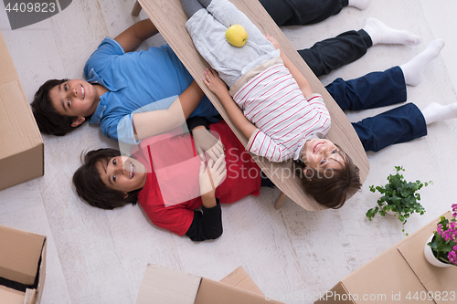 Image of boys with cardboard boxes around them top view