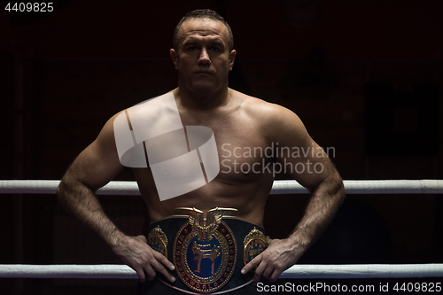 Image of kick boxer with his championship belt