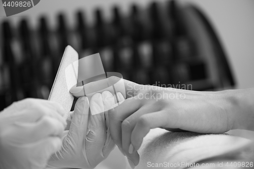 Image of Woman hands receiving a manicure