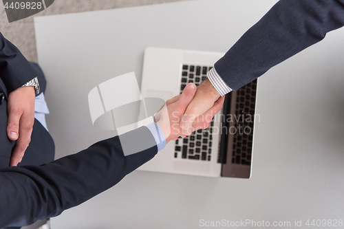 Image of cloasing the deal in modern office interior top view