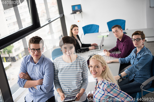 Image of group of Business People Working With Tablet in startup office