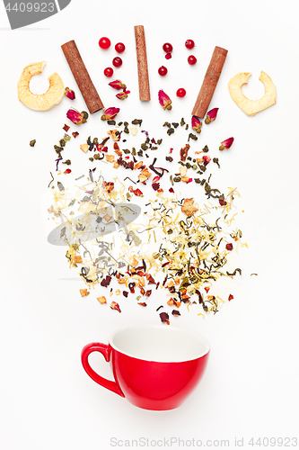 Image of Beautiful and delicious dried tea leaves with herbs, flowers, berries, fruits, coconut slices, cocoa and coffee chips. Detailed studio shoot with selective focus and abstract blurred background