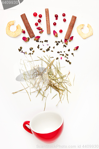 Image of Beautiful and delicious dried tea leaves with herbs, flowers, berries, fruits, coconut slices, cocoa and coffee chips. Detailed studio shoot with selective focus and abstract blurred background