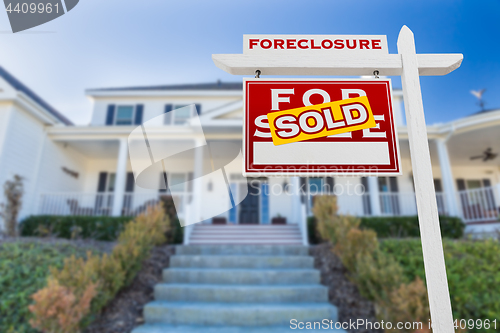 Image of Left Facing Foreclosure Sold For Sale Real Estate Sign in Front 