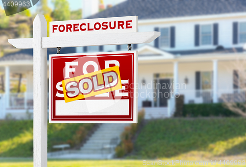 Image of Right Facing Foreclosure Sold For Sale Real Estate Sign in Front