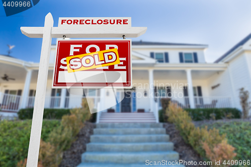 Image of Right Facing Foreclosure Sold For Sale Real Estate Sign in Front