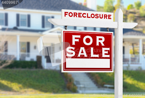 Image of Left Facing Foreclosure For Sale Real Estate Sign in Front of Ho