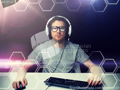 Image of man in headset computer over hexagons projection