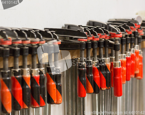 Image of one-handed bar clamps hanging on wall