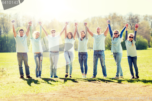 Image of group of volunteers celebrating success in park