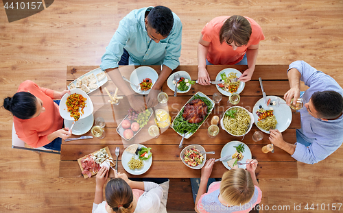 Image of group of people eating at table with food