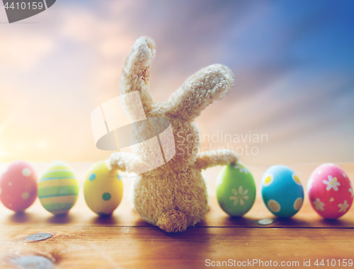 Image of close up of colored easter eggs and toy bunny