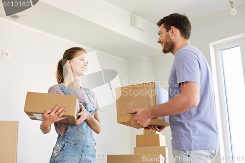 Image of happy couple with boxes moving to new home