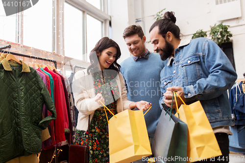 Image of friends shopping bags at vintage clothing store