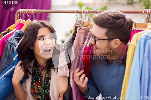 Image of happy couple having fun at vintage clothing store