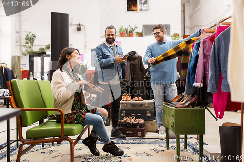 Image of friends choosing clothes at vintage clothing store