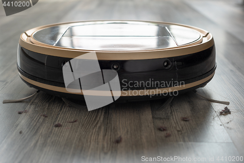 Image of robotic vacuum cleaner on laminate wood floor