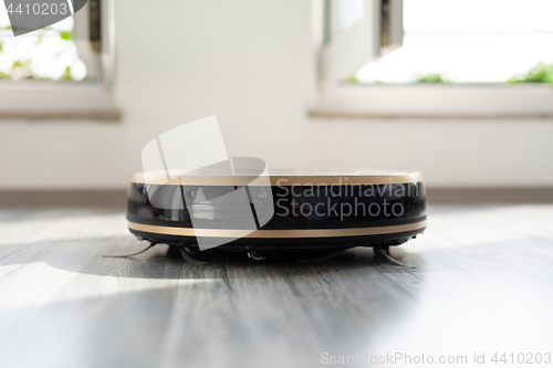 Image of robotic vacuum cleaner on laminate wood floor