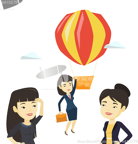 Image of Business woman hanging on balloon.