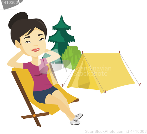 Image of Woman sitting in folding chair in the camp.