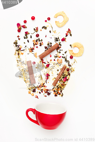 Image of Beautiful and delicious dried tea leaves with herbs, flowers, berries, fruits, coconut slices, cocoa and coffee chips. Detailed studio shoot with selective focus and abstract blurred background