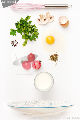 Image of The falling ingredients of fried egg. Healthy breakfast ingredients.