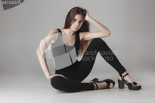 Image of Young beautiful happy woman on gray background