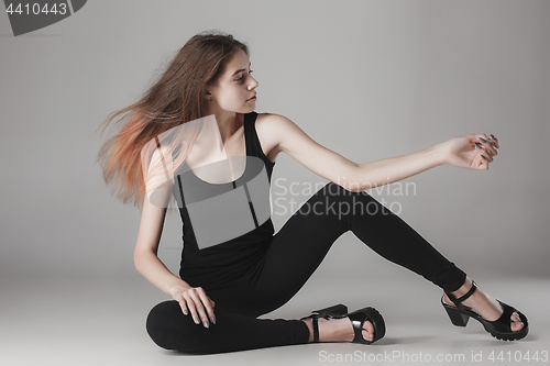 Image of Young beautiful happy woman on gray background