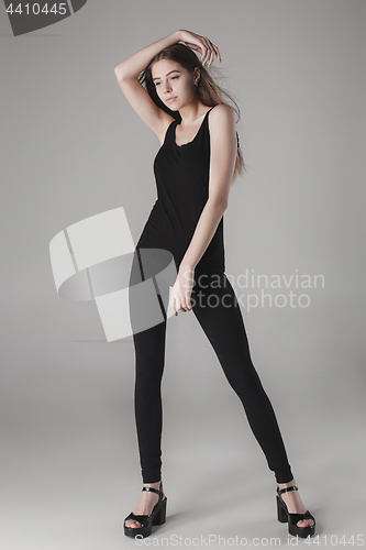 Image of Young beautiful happy woman on gray background
