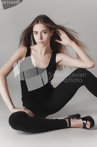 Image of Young beautiful happy woman on gray background