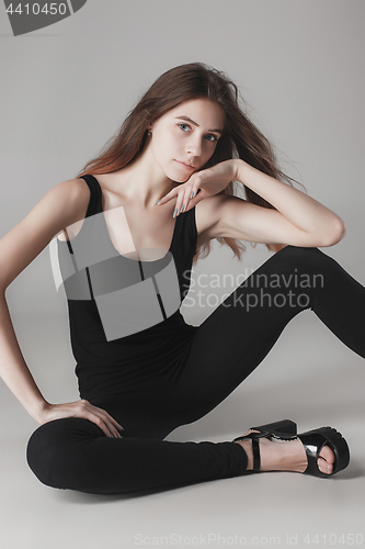 Image of Young beautiful happy woman on gray background