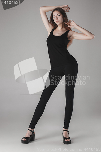 Image of Young beautiful happy woman on gray background