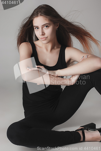 Image of Young beautiful happy woman on gray background