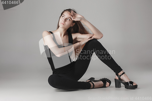 Image of Young beautiful happy woman on gray background