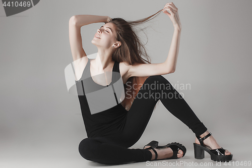 Image of Young beautiful happy woman on gray background