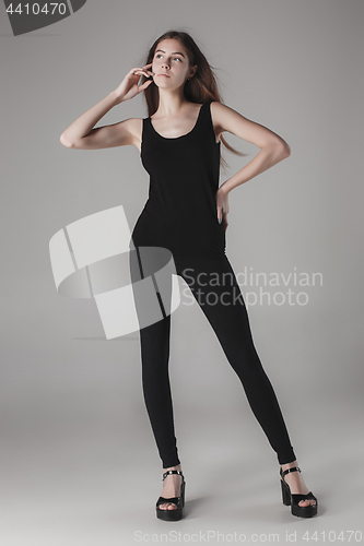 Image of Young beautiful happy woman on gray background