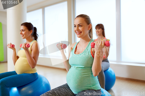 Image of pregnant women training with exercise balls in gym